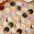 All thirty floral Thank You sticker designs laid out on a table